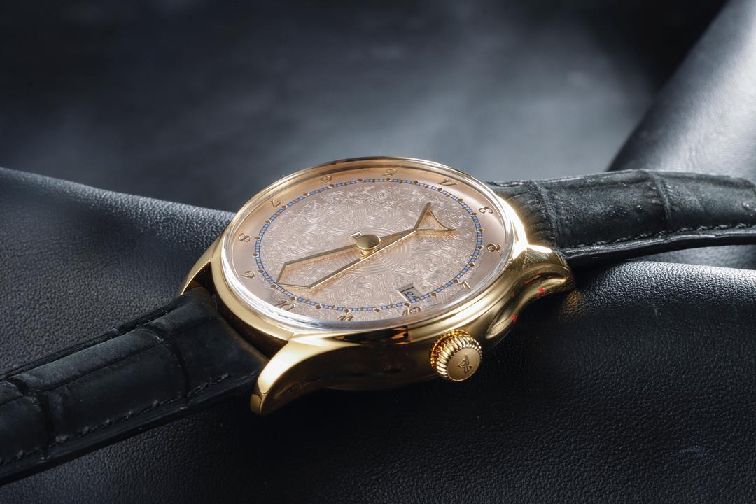 Gold-toned Auctor Zen wristwatch photographed from the side
